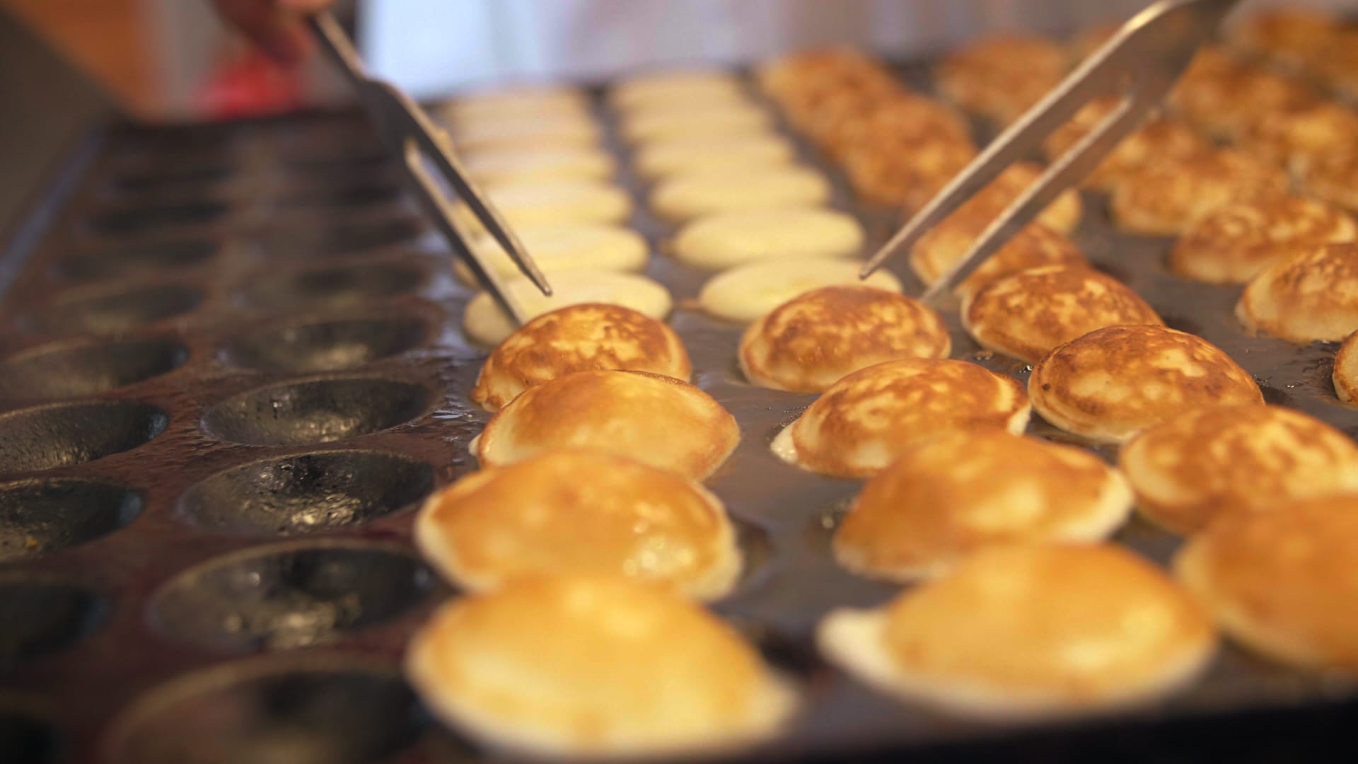 Poffertjes being made in poffertjes pan