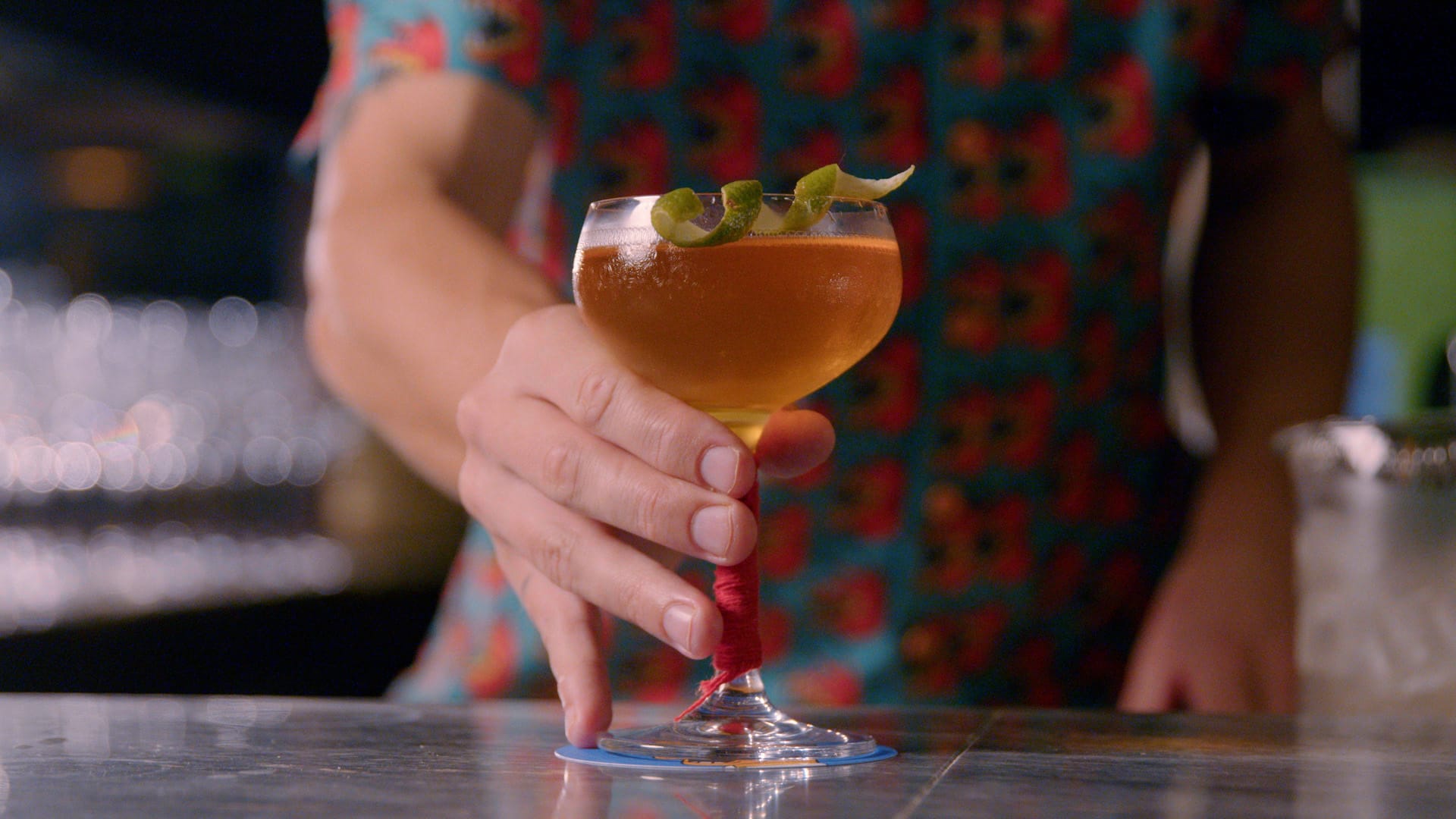 Bar tender serves a drink on the bar